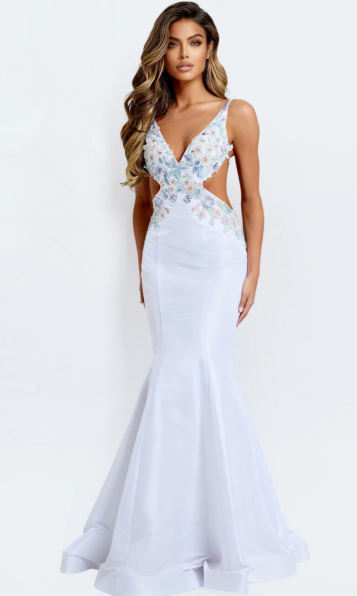 A woman stands against a plain light background wearing the Jovani 48176 long prom dress—a fitted white mermaid gown with floral embroidery on the bodice and side cutouts. This floor-length dress blends modern style with classic sophistication.